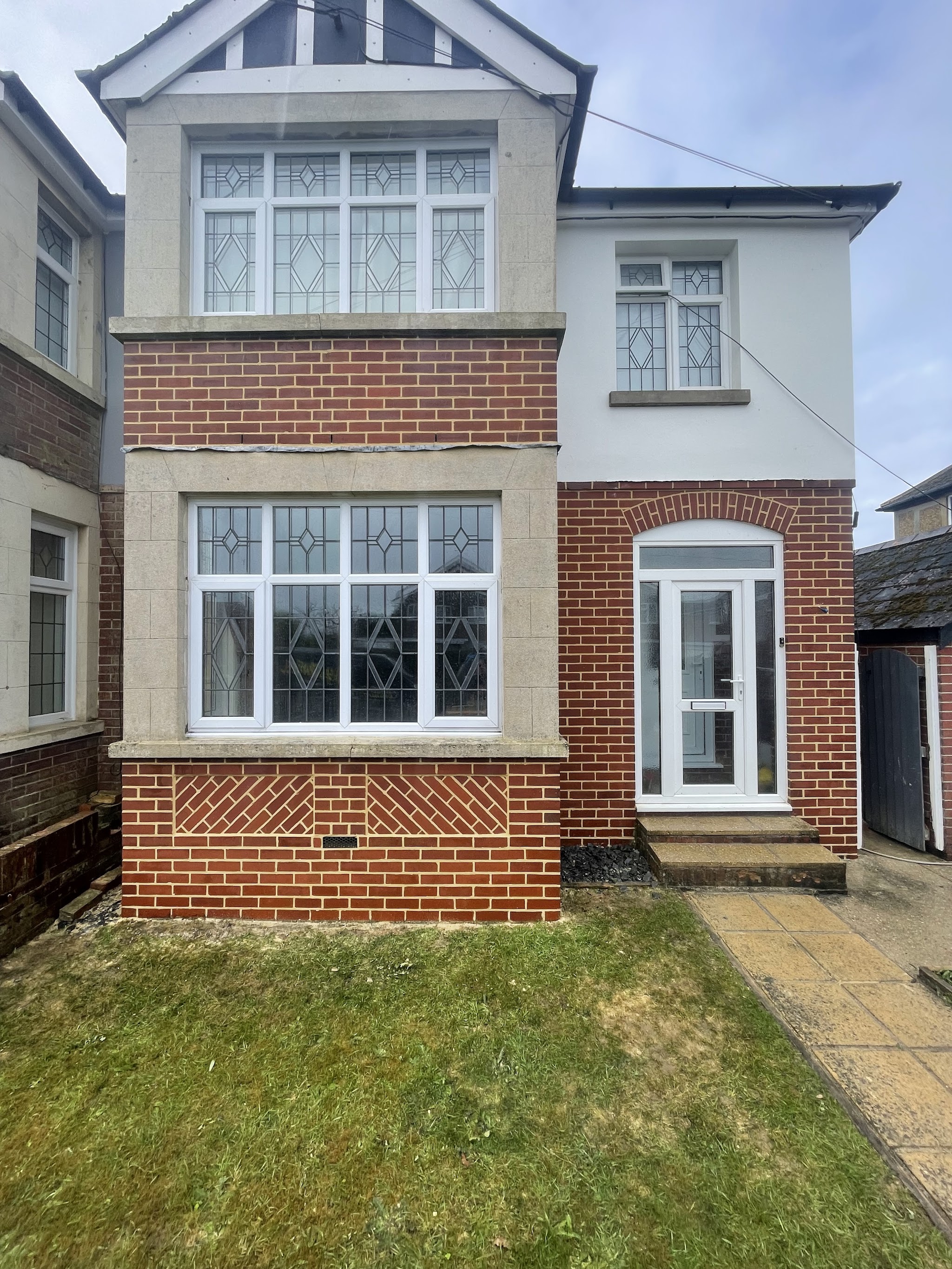 A 1930s semi with freshly repointed red brick bays